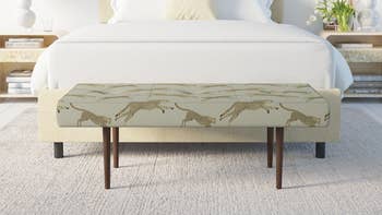 cheetah print beige bench at the foot of the bed