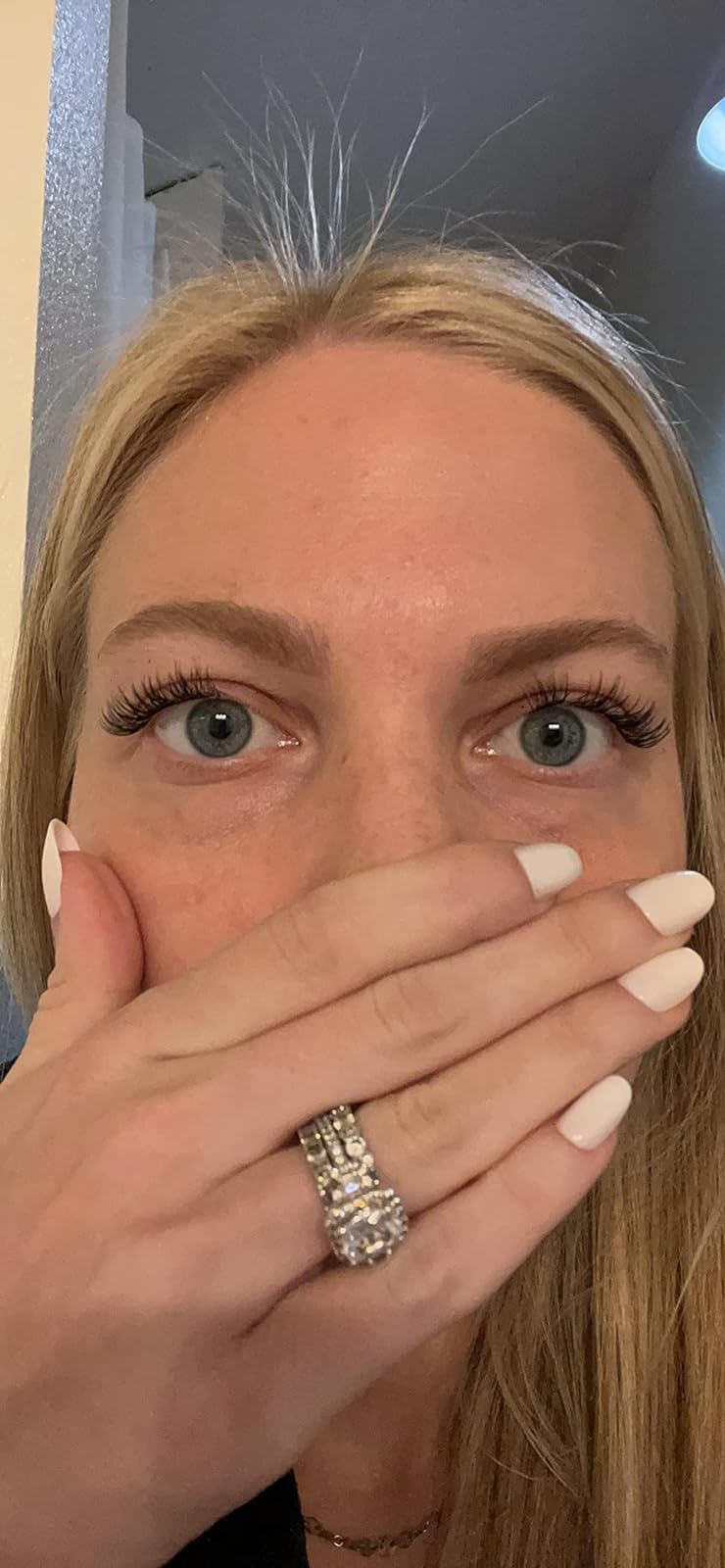 reviewer looking shocked and showing off their eyelashes, which look long