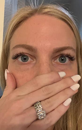reviewer looking shocked and showing off their eyelashes, which look long