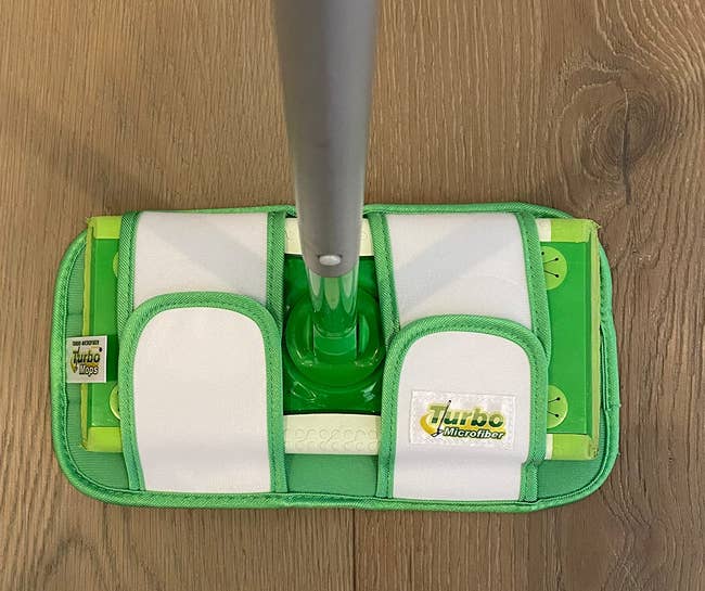 a reviewer photo of the reusable pad mounted on a Swiffer Sweeper 