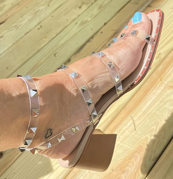 Reviewer wearing clear strappy heels