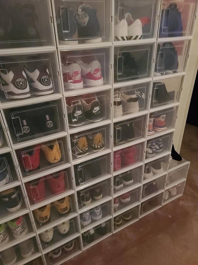 A postulation of sneakers neatly organized successful wide retention boxes, including assorted fashionable brands and styles, perfect for sneaker enthusiasts