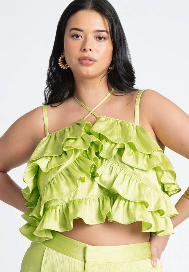 Woman in a green ruffled top and matching skirt