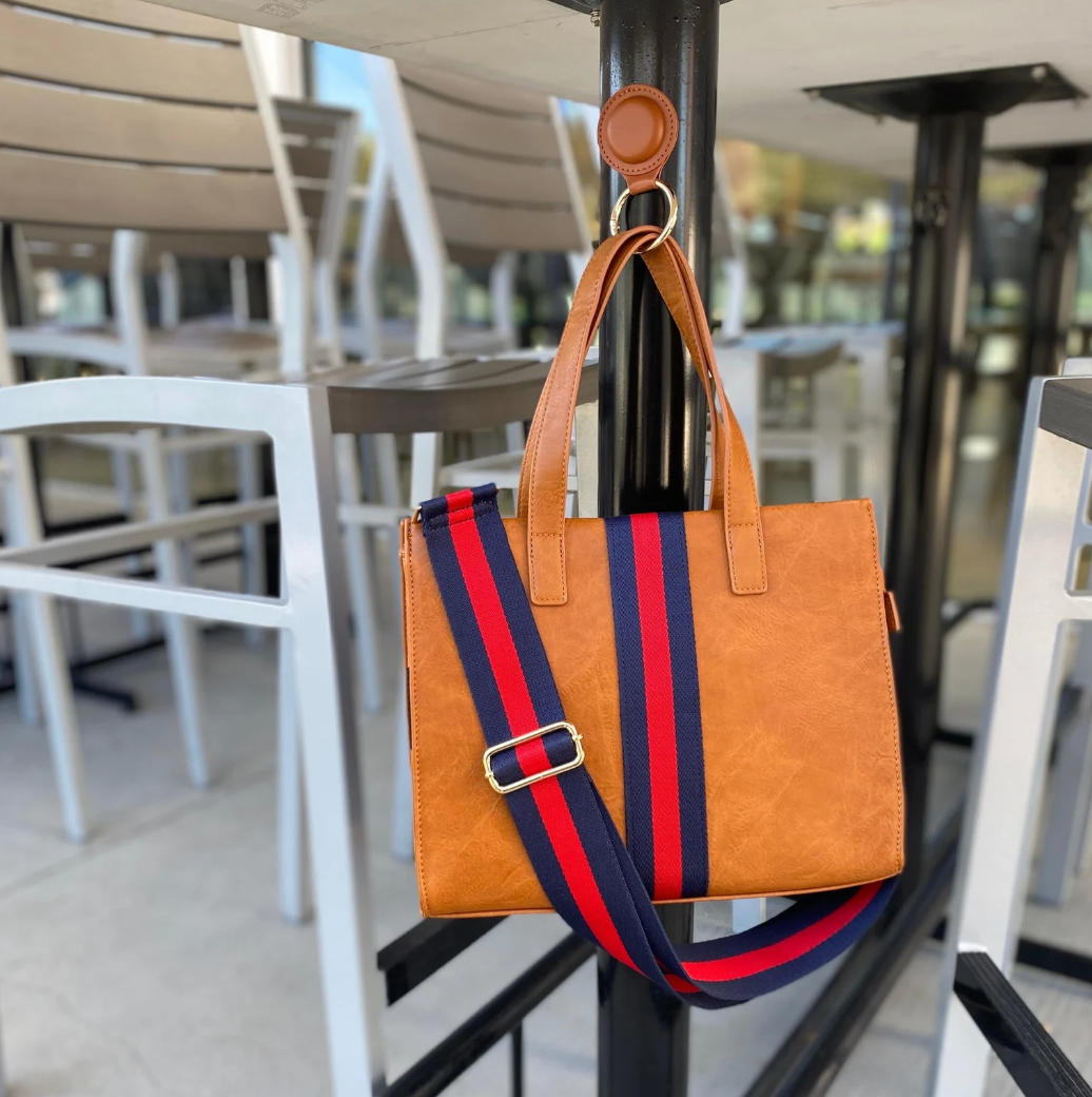 a bag held up off the ground by a magnetic keychain