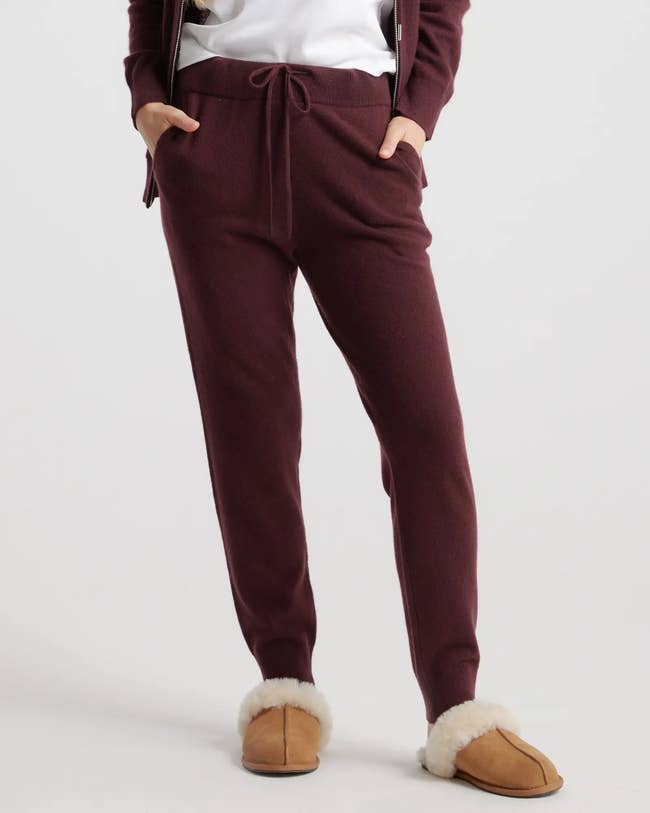 model wearing the sweatpants in red