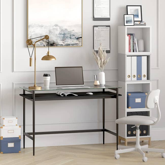 Contemporary home office setup with desk, laptop, chair, and storage shelves