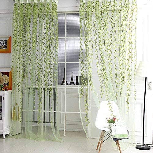 two of the green vine drapes hanging in a window