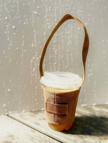 cup of iced coffee inside the canvas holder
