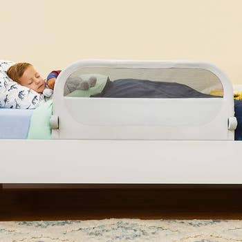 adjustable bed rail raised while child sleeps