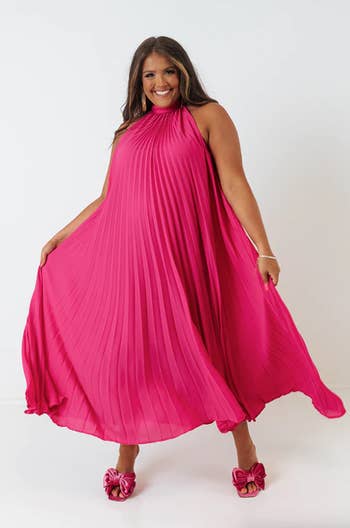 another model wearing the pink non-belted dress to show the pleats