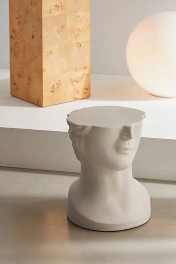 Sculptural side table with a modern bust design, featuring a flat top, suitable for home decor