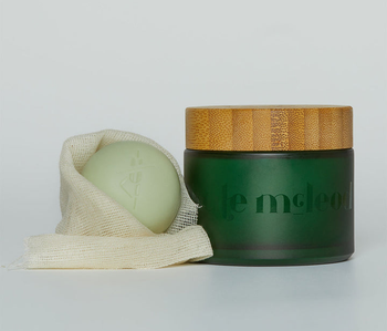 The Kate McLeod facial stone wrapped in muslin next to its glass case