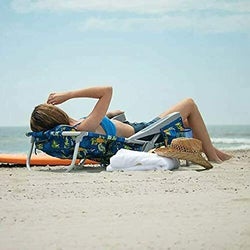 Person laying flat in the beach chair on a beach