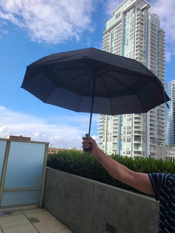 Reviewer holding the open umbrella