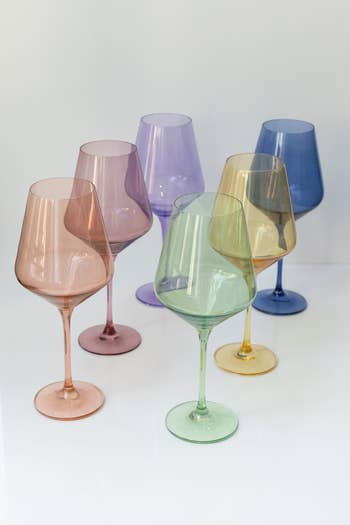 Six stemware glasses in various pastel tones arranged in two rows