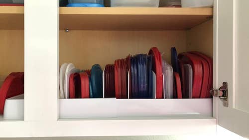 a reviewer using the storage on a shelf with the lids lined up neatly
