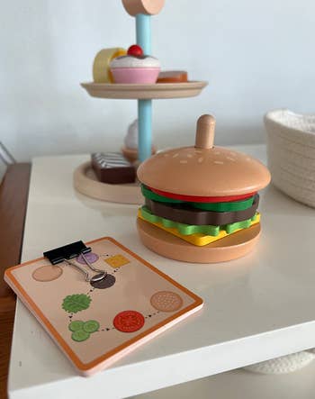 reviewer image of burger stacking toy with images of what to put on it