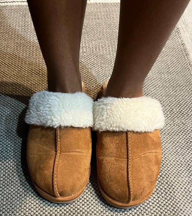 Cozy slippers with soft, fluffy lining connected  someone's feet implicit    a textured rug, cleanable   for location  comfort