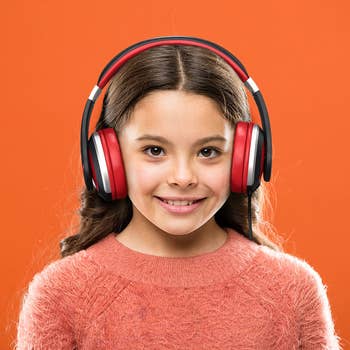 kid in black and red corded headphones