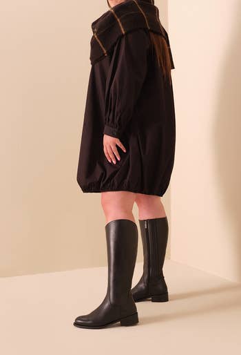 model wearing the black flat riding boots