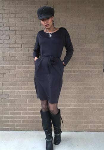 another reviewer wearing the black dress with tights and black boots