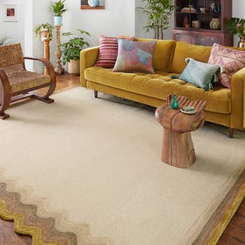a yellow and beige rug in a matching living room