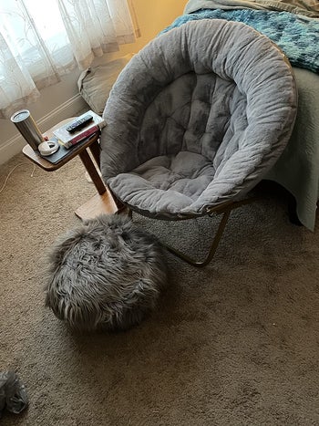 reviewer photo of gray saucer chair in bedroom