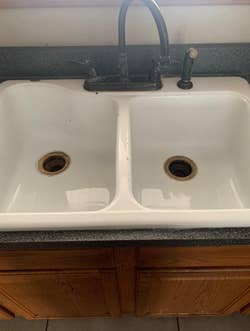 reviewers clean sink after scrubbing using drill brush