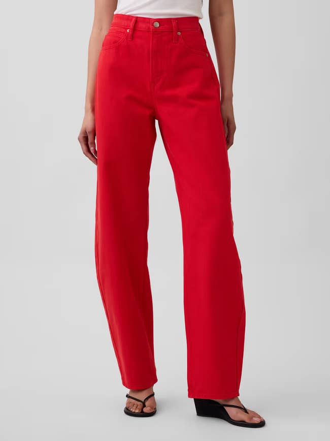Person successful  high-waisted, wide-leg pants and sandals, showcasing casual manner  suitable for a buying  article