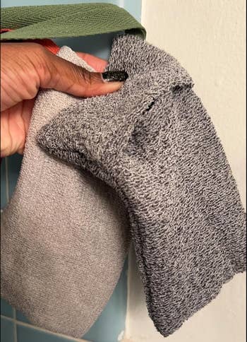 Textured gray and beige exfoliating washcloths held in a person's hand, suitable for skincare routines