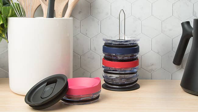 the organizer loaded up with tumbler lids on a kitchen counter 