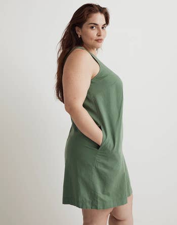 a model in a green tank dress with pockets
