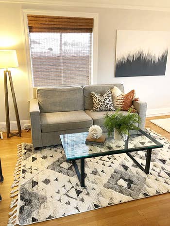 reviewer image of the ivory/grey rug in a living space