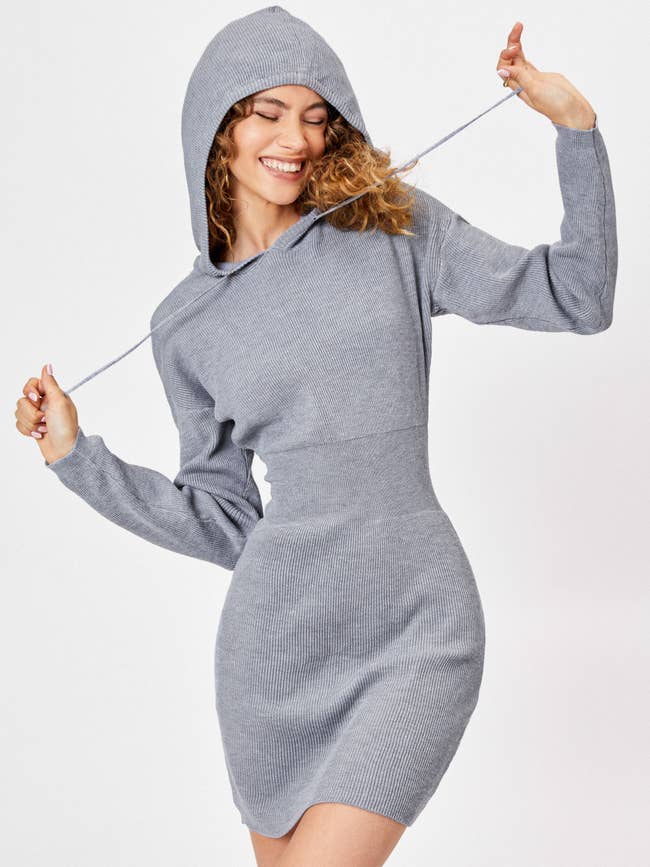 a model wearing a rib knit gray dress with a hood 