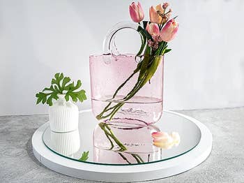 The pink vase with tulips in it