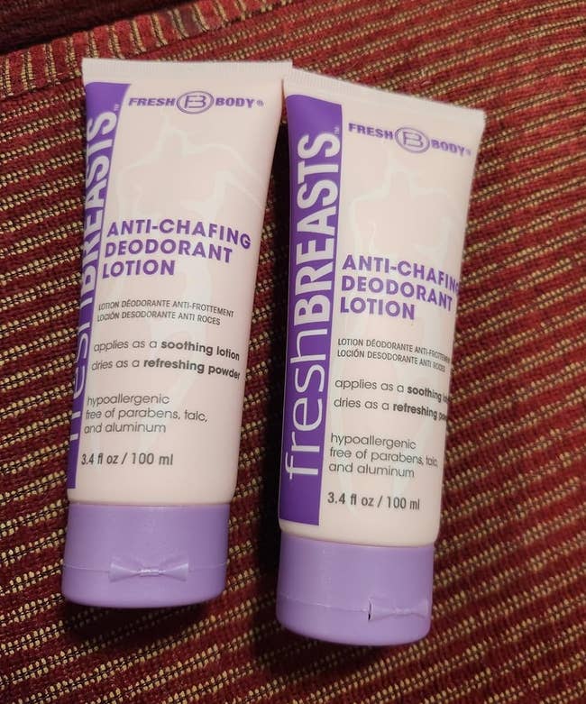 Two tubes of Fresh Breasts anti-chafing deodorant lotion prevarication connected a textured surface