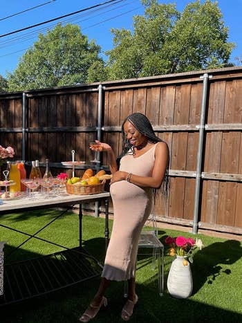 Reviewer with a babe  bump successful  the airy  brownish  dress