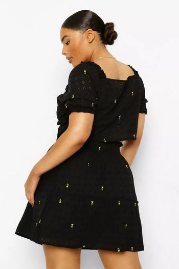 back view of model wearing the black skirt set