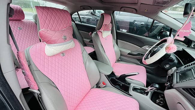 Reviewer photo of a car with pink quilted seat covers on every seat and on the steering wheel