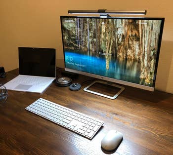reviewer's Screenbar on a monitor lighting up their workspace