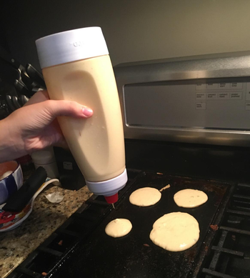 reviewer squeezing batter into circles on a pan