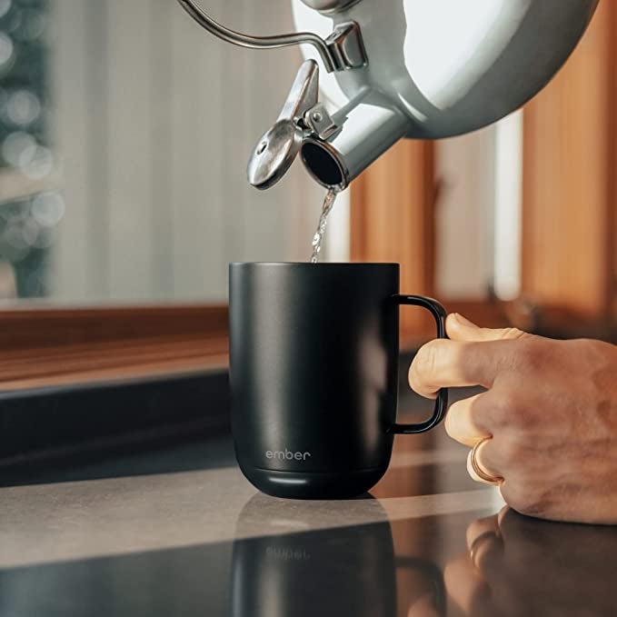 model pouring water into mug