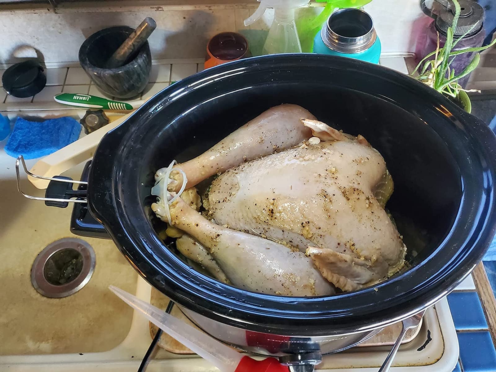reviewer photo of a 13-pound turkey in the slow cooker and there's plenty of room in the pot