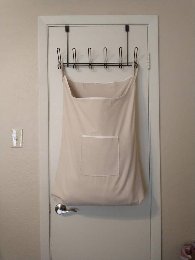 Door-mounted laundry hamper with hooks, showcasing convenient retention successful a minimal space