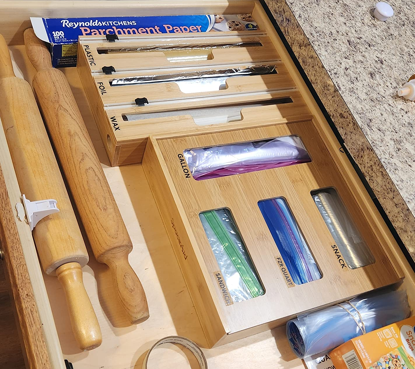 a reviewer shows both wooden organizers in their drawer