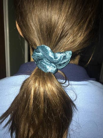 image of the blue velvet scrunchie in a reviewer's hair