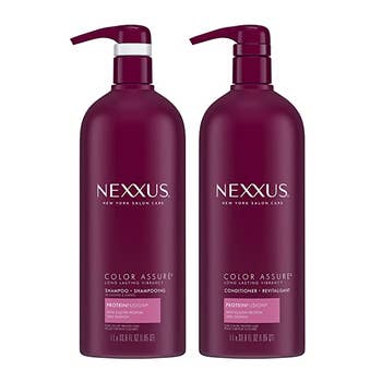 Two purple shampoo and conditioner bottles with pumps on white background