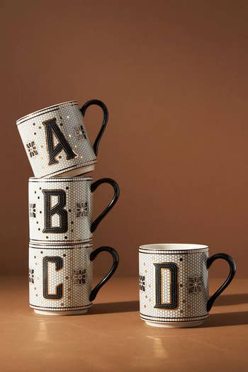 four mugs stacked with letters A-D on the side