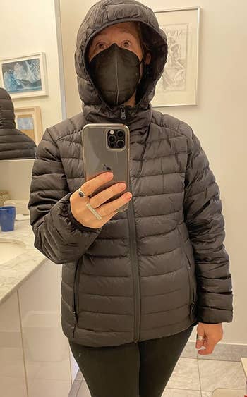 a reviewer wearing the achromatic  jacket
