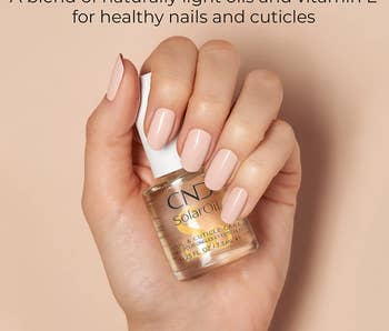 model holding the cuticle care solution